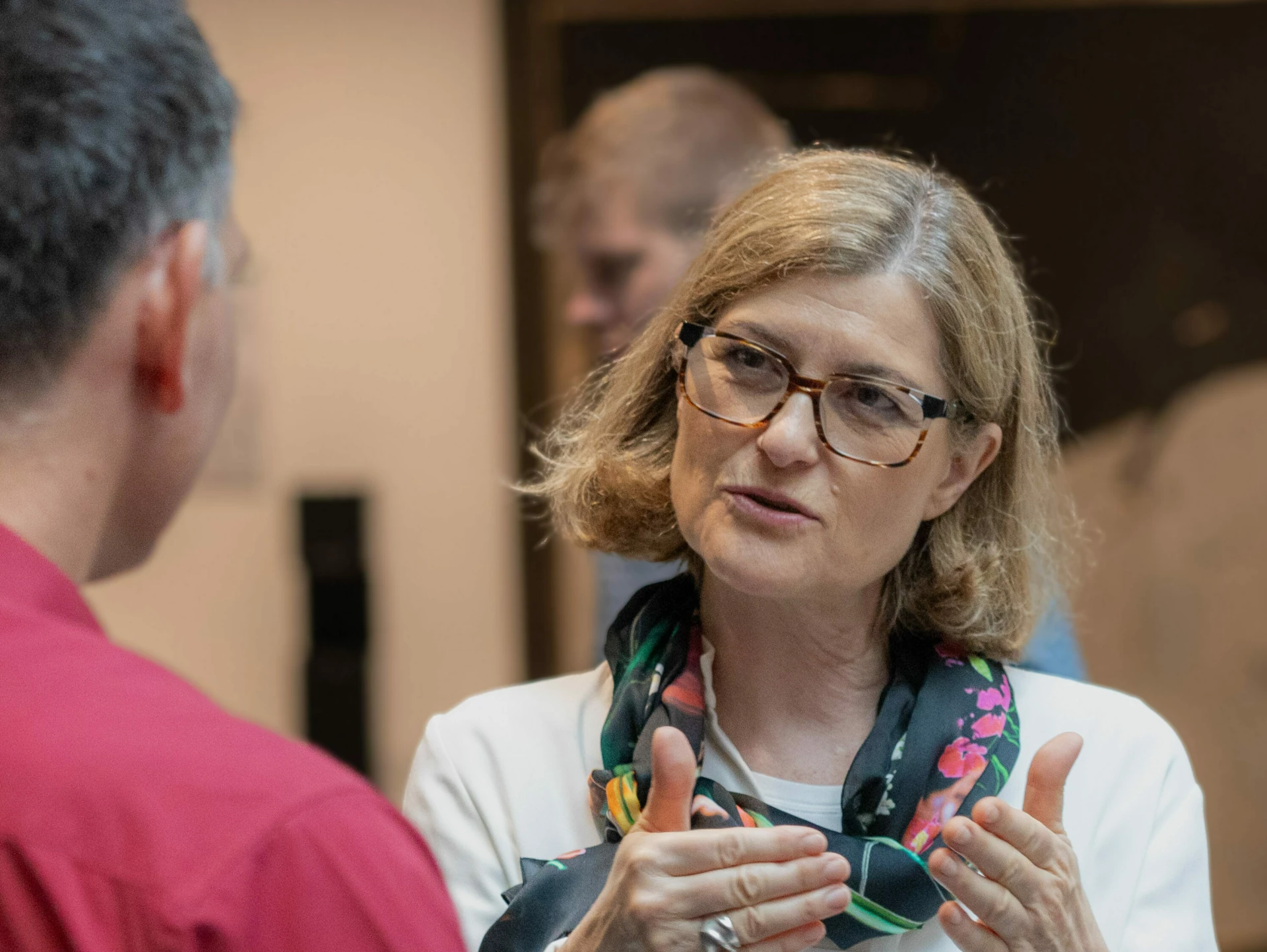 Discussion between a woman and a man about AI upskilling at an AI conference.