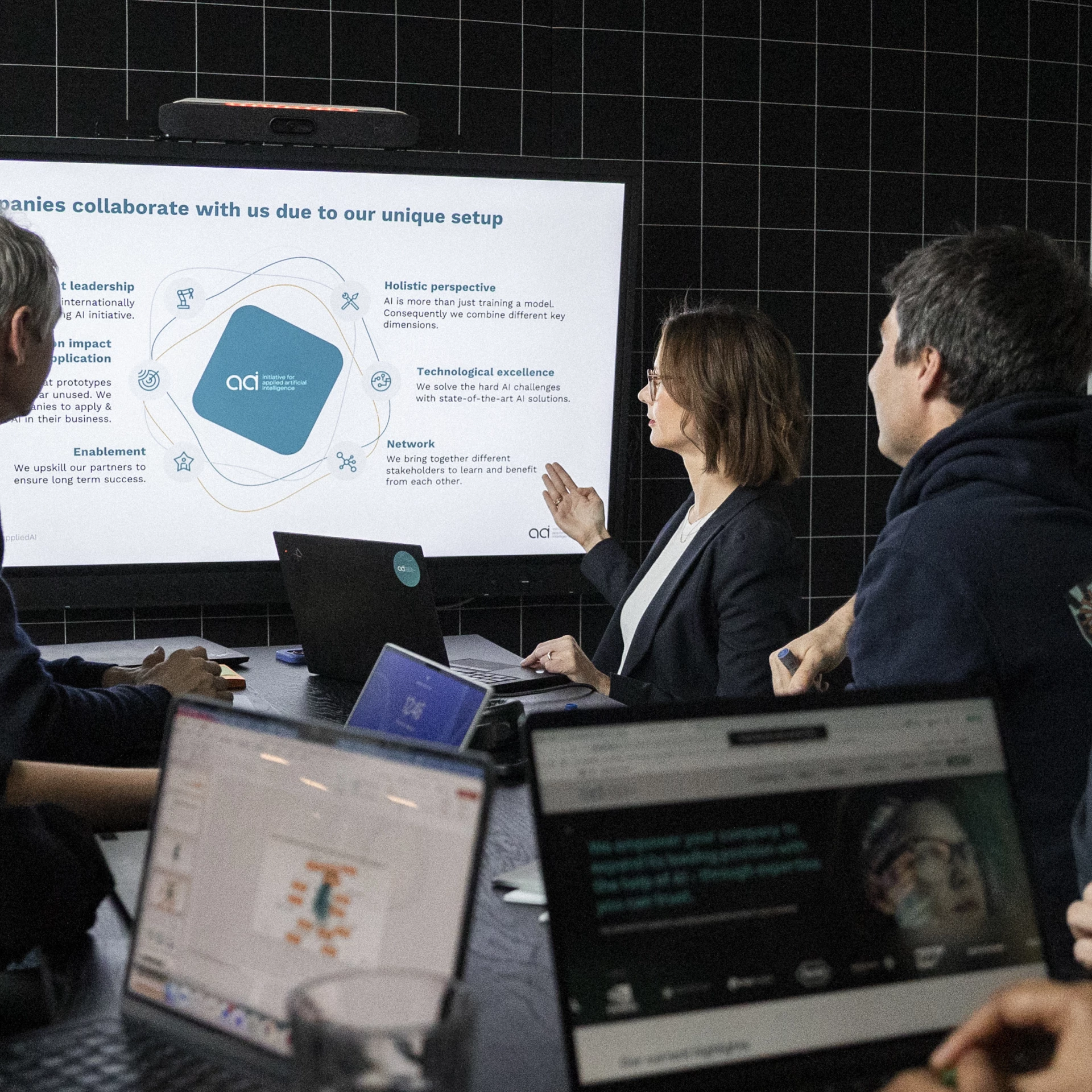 A team of 5 AI experts talks about the appliedAI offering shown on a screen